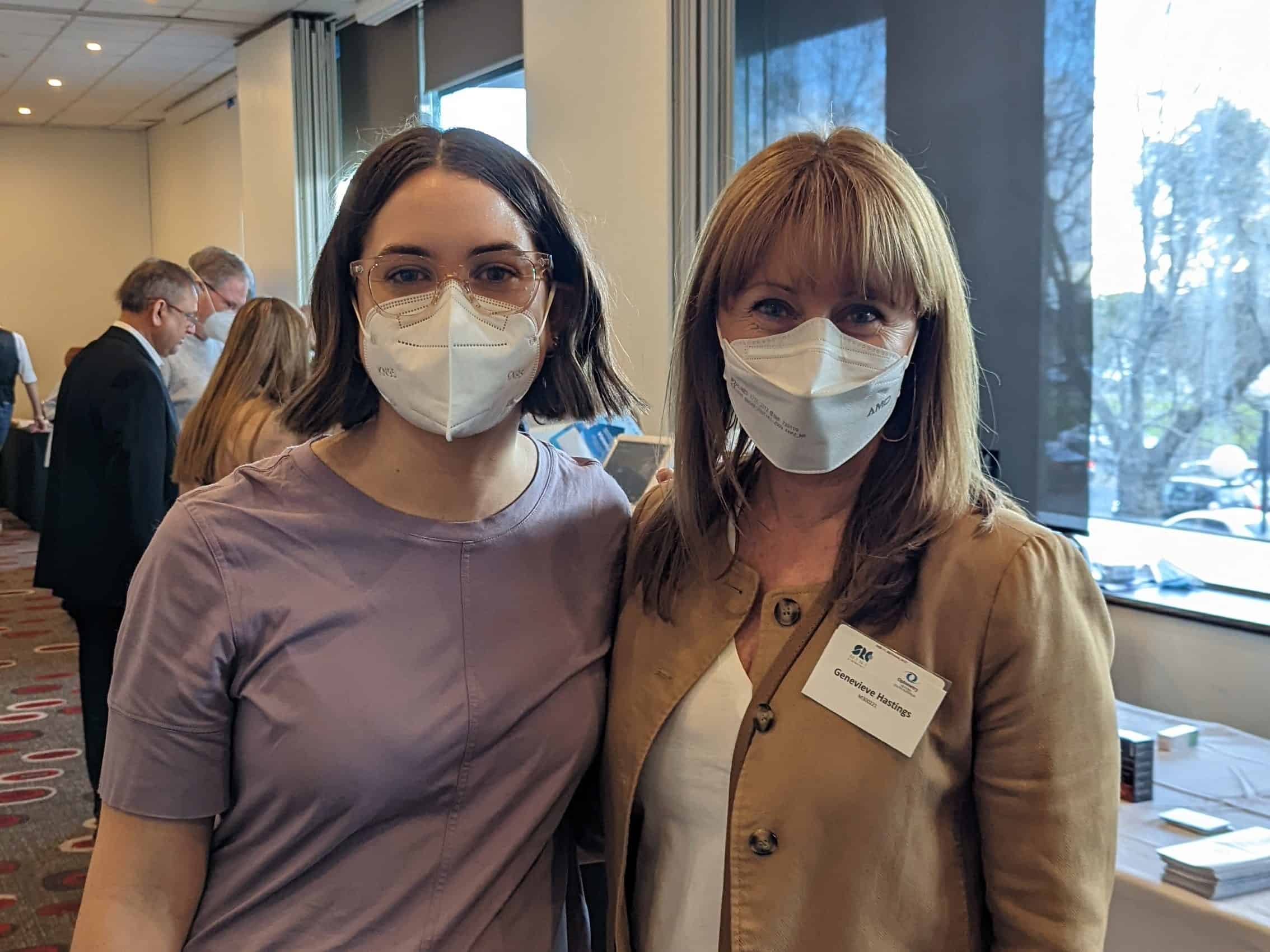 Optometrists Laura and Genevieve in Masks at a conference